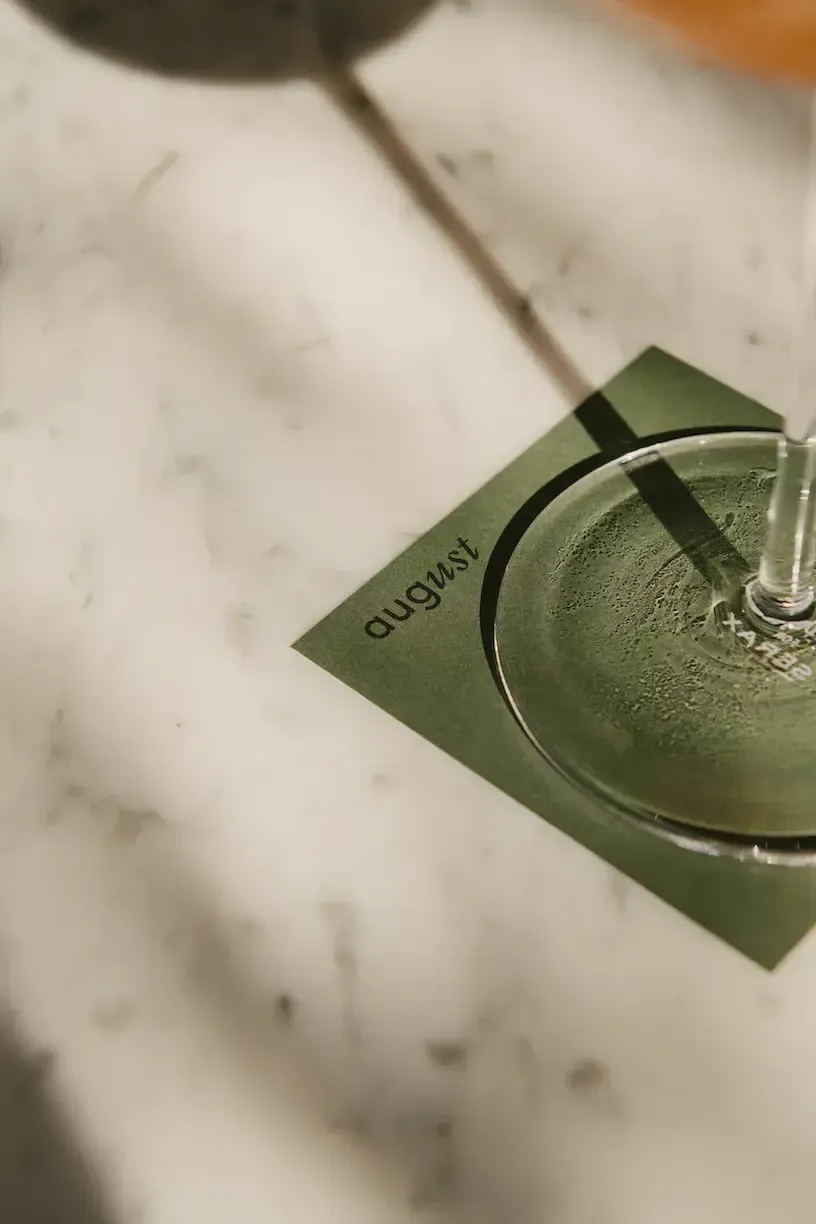 August, Europe — Green ceramic dish with condensation on marble surface, minimalist luxury hospitality design detail.