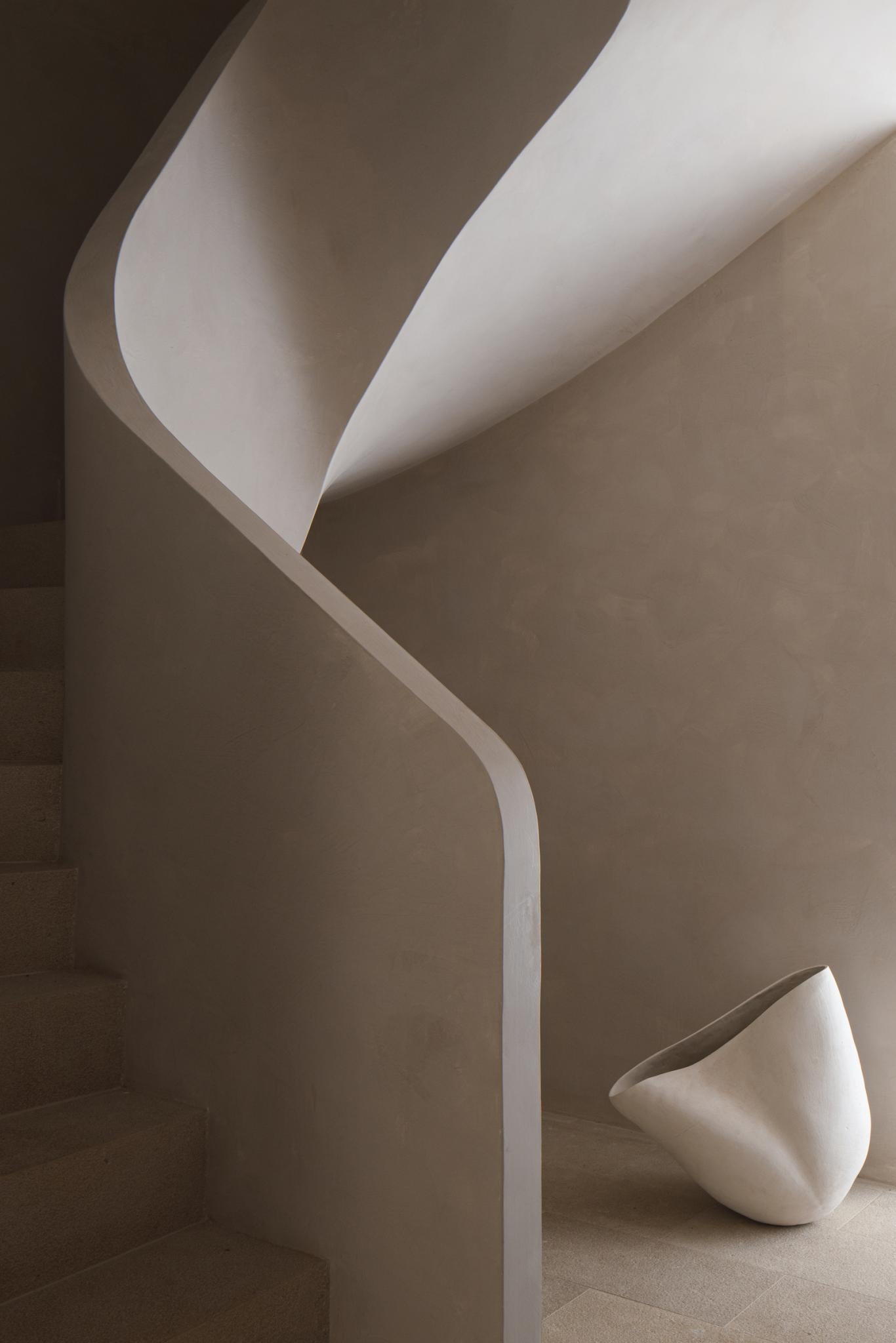 Can Gaspar, Balearic Islands, Spain — Curved white plaster walls and sculptural pottery vessel in minimalist gallery space with soft natural light.