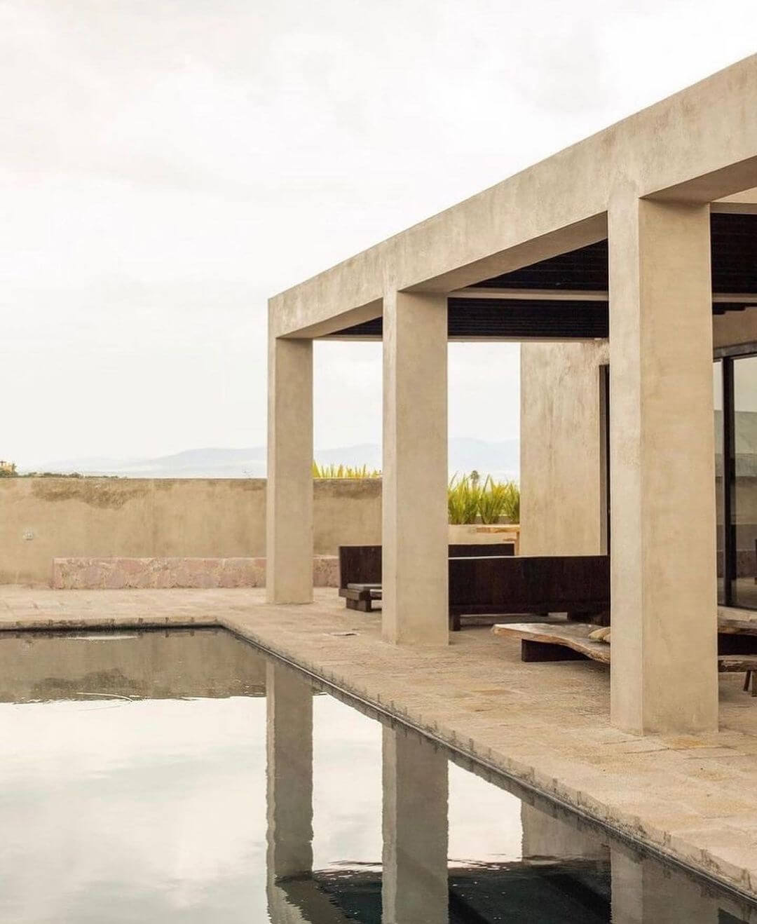 Villa ITO, Mexico — Minimalist concrete pergola with reflecting pool, modernist architecture overlooking coastal landscape at dusk.