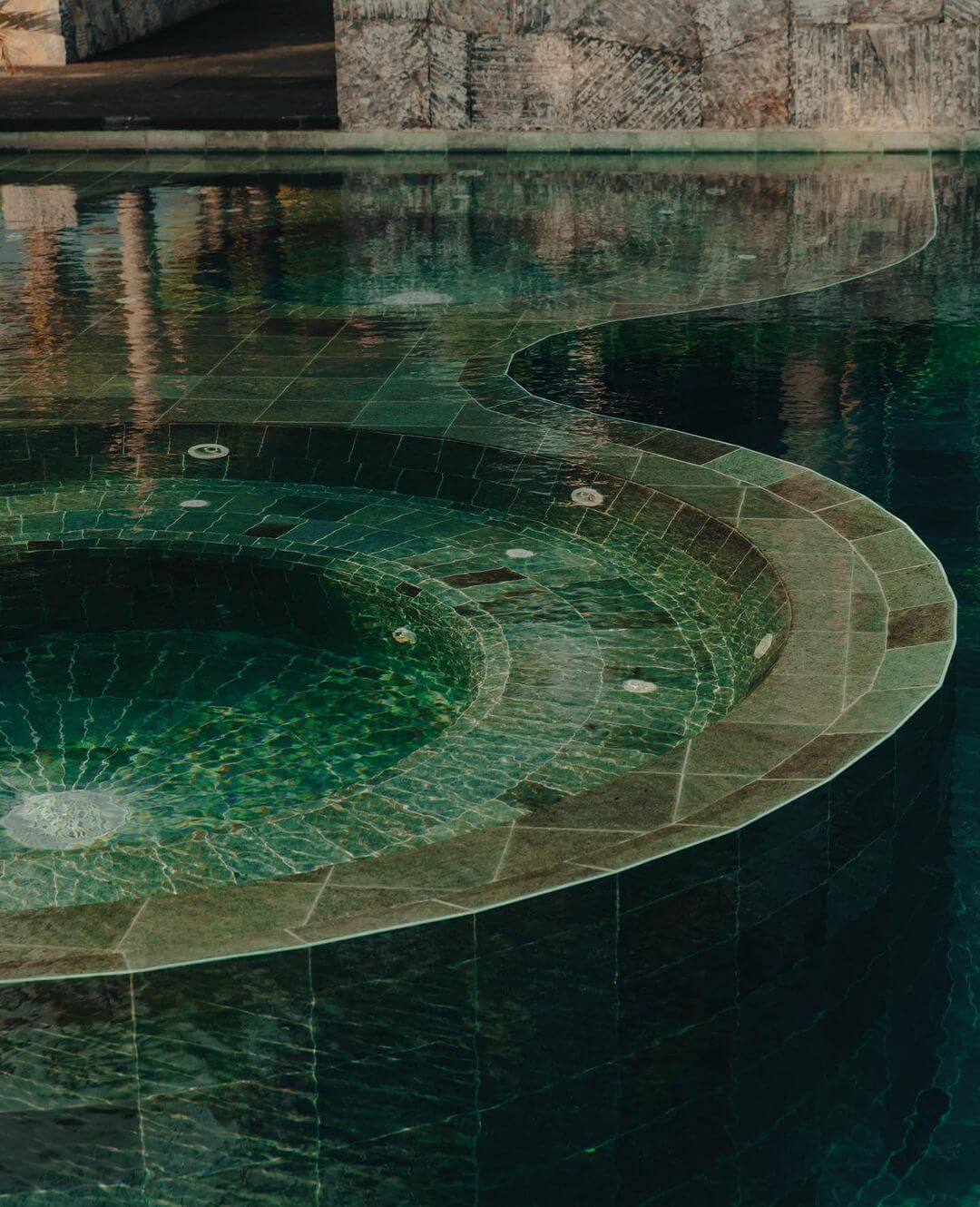 Hotelito MUSA, Mexico — Geometric tile basin with crystalline water, architectural concrete edges, and reflected stonework creating layered depth in luxury spa design.
