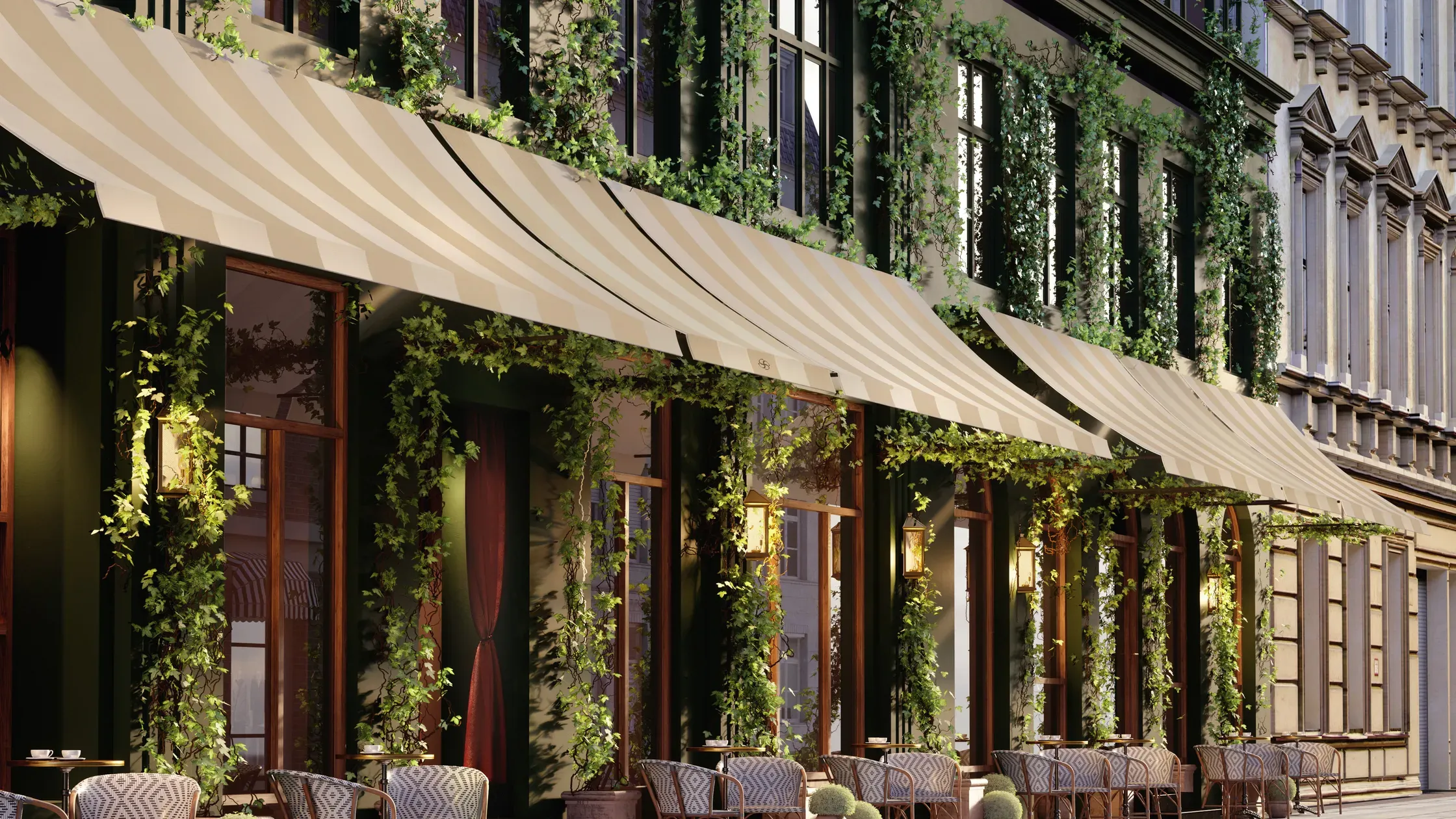 Hotel Sanders, Europe — Ivy-draped façade with striped awning, wooden-framed windows, and geometric-patterned outdoor seating under soft evening light.