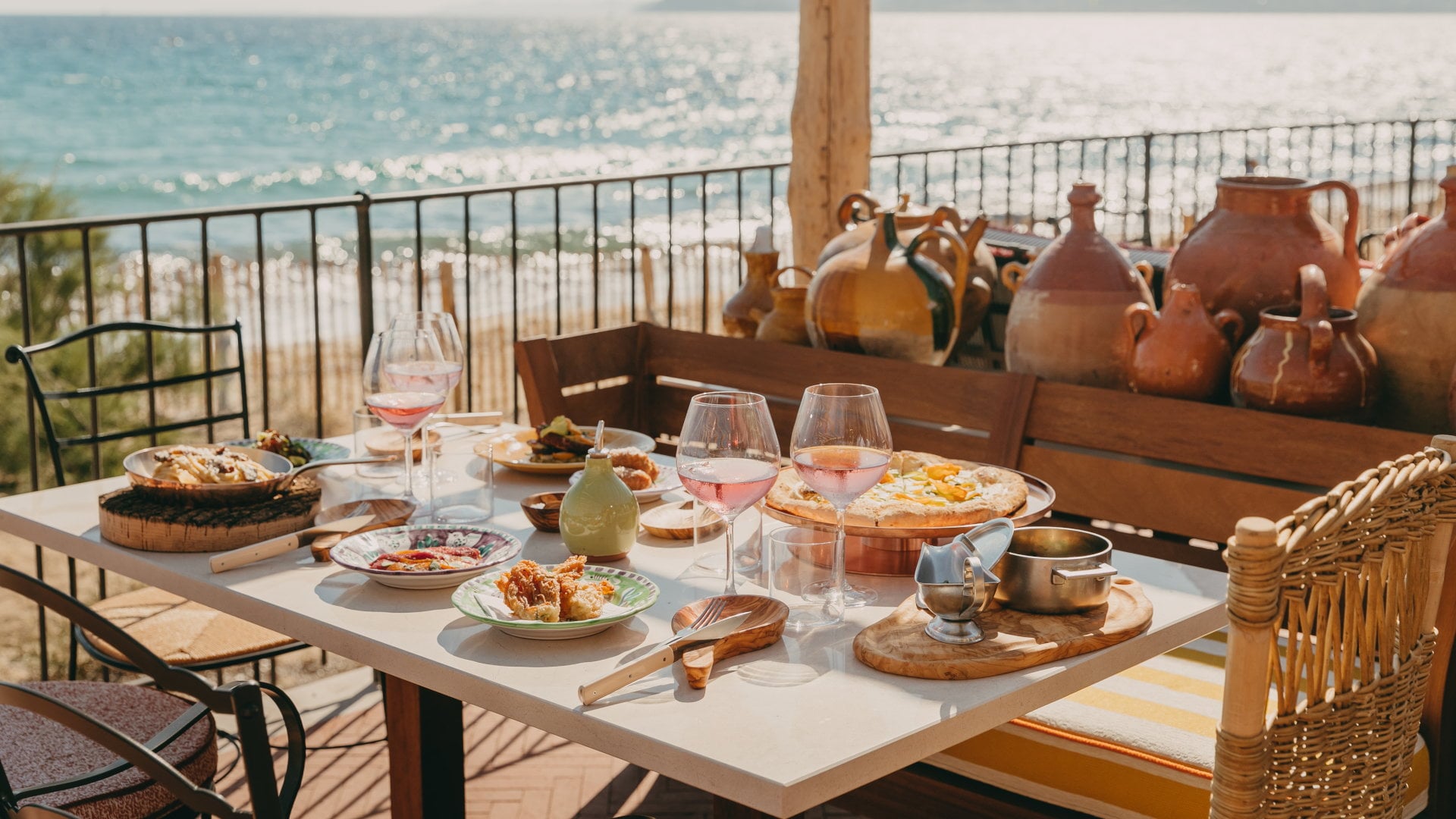 Brigantine, Europe — Terrace dining with rosé wine, Mediterranean seafood, ceramic vessels, sea view, golden hour light, coastal luxury hospitality.