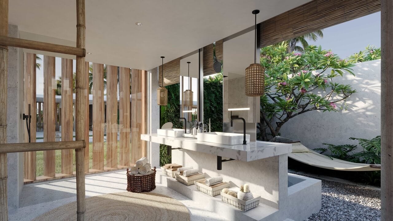 Cap Karoso, Asia — Minimalist bathroom with marble vanity, woven pendant lights, indoor green wall, and garden courtyard visible through floor-to-ceiling windows.