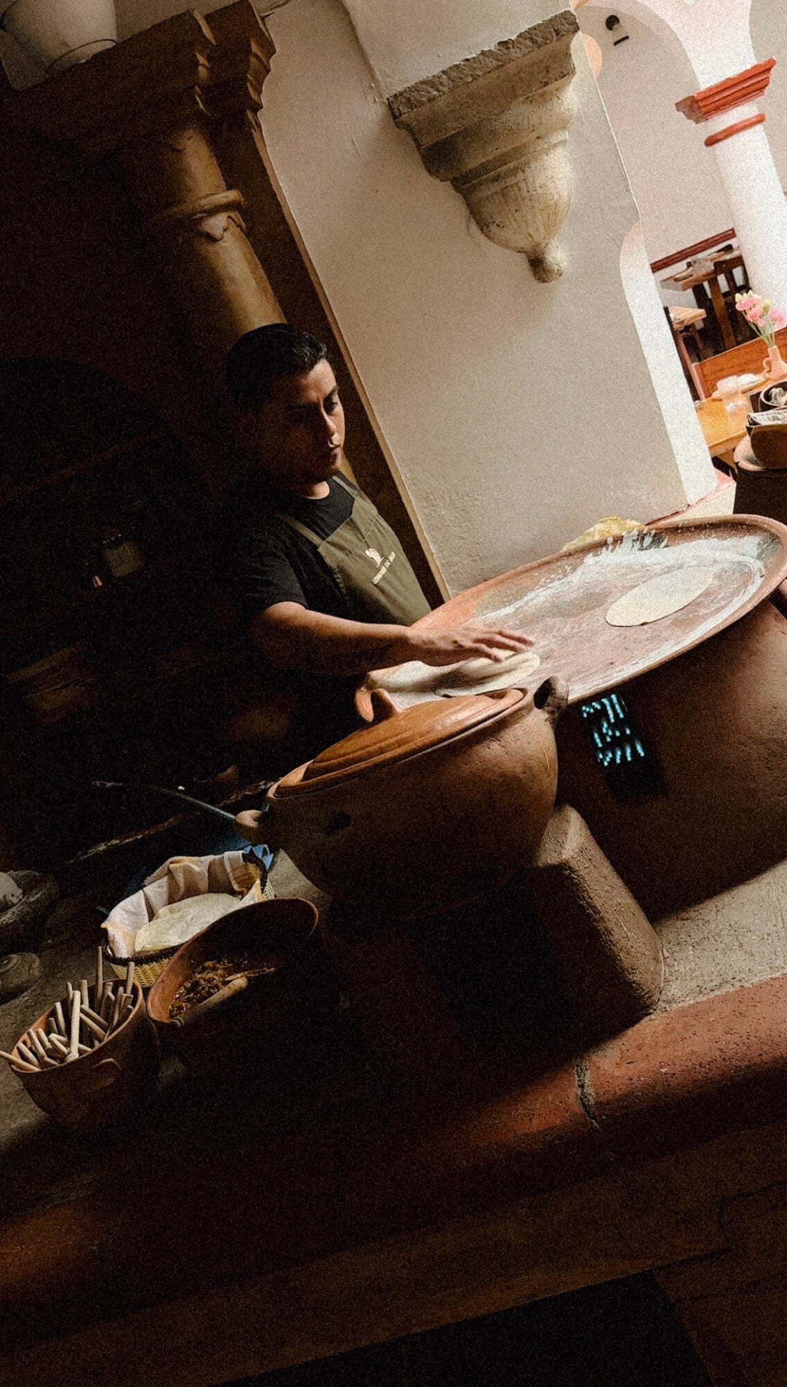 Levadura de Olla, Mexico — Artisan hands shaping traditional clay pottery with natural light illuminating handcrafted ceramic vessels and architectural details.