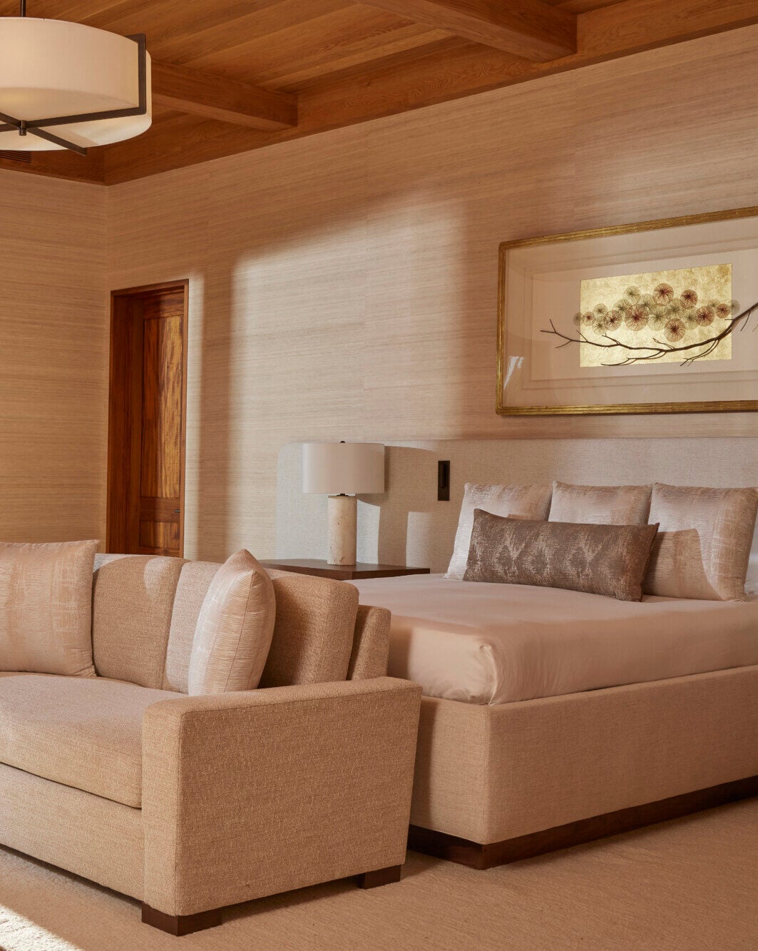 Sensei Porcupine Creek, North America — Modern bedroom with warm wood ceiling, neutral linen furnishings, and natural light casting geometric shadows across textured walls.