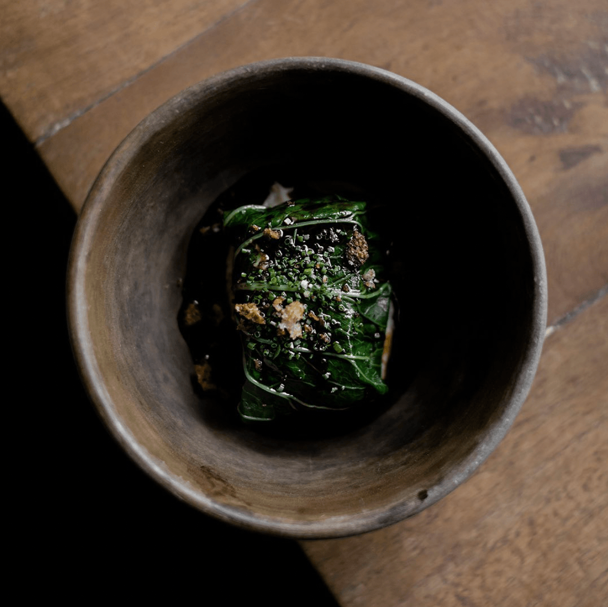 Em, Mexico — Earthenware mortar with fresh herbs and spices, artisanal culinary detail showcasing local ingredients and rustic hospitality design.