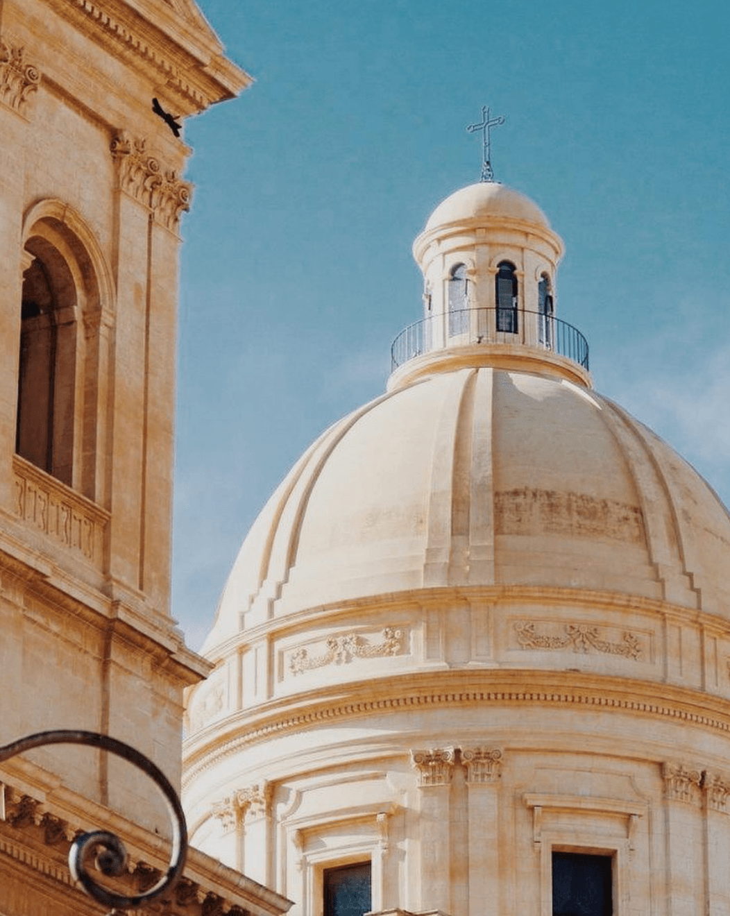 Art Tour — Neoclassical dome with cream limestone exterior and cross-topped cupola, architectural detail of European religious building near luxury hotel.