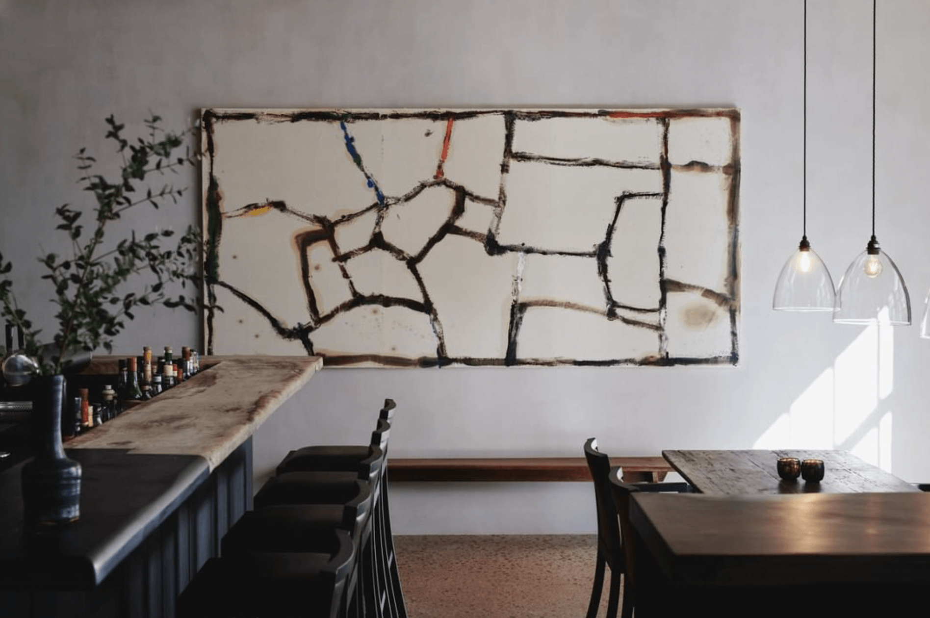Bar & Smokers Lounge, Europe — Industrial branch wall installation with colored wire accents above dark dining tables, pendant lights, and minimalist interior design.