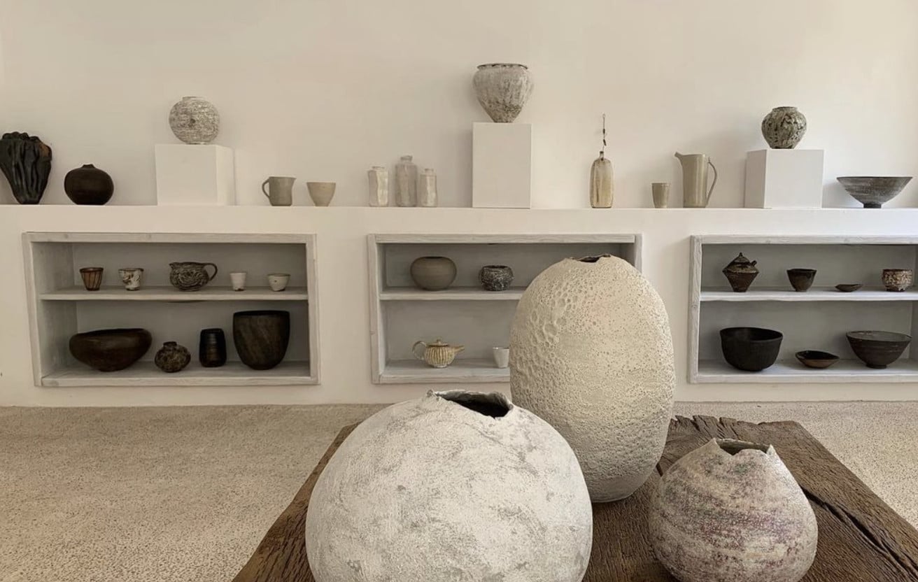 Gres Gallery, Balearic Islands — Minimalist ceramics display with textured vessels, neutral palette, recessed shelving, and natural light in contemporary gallery space.