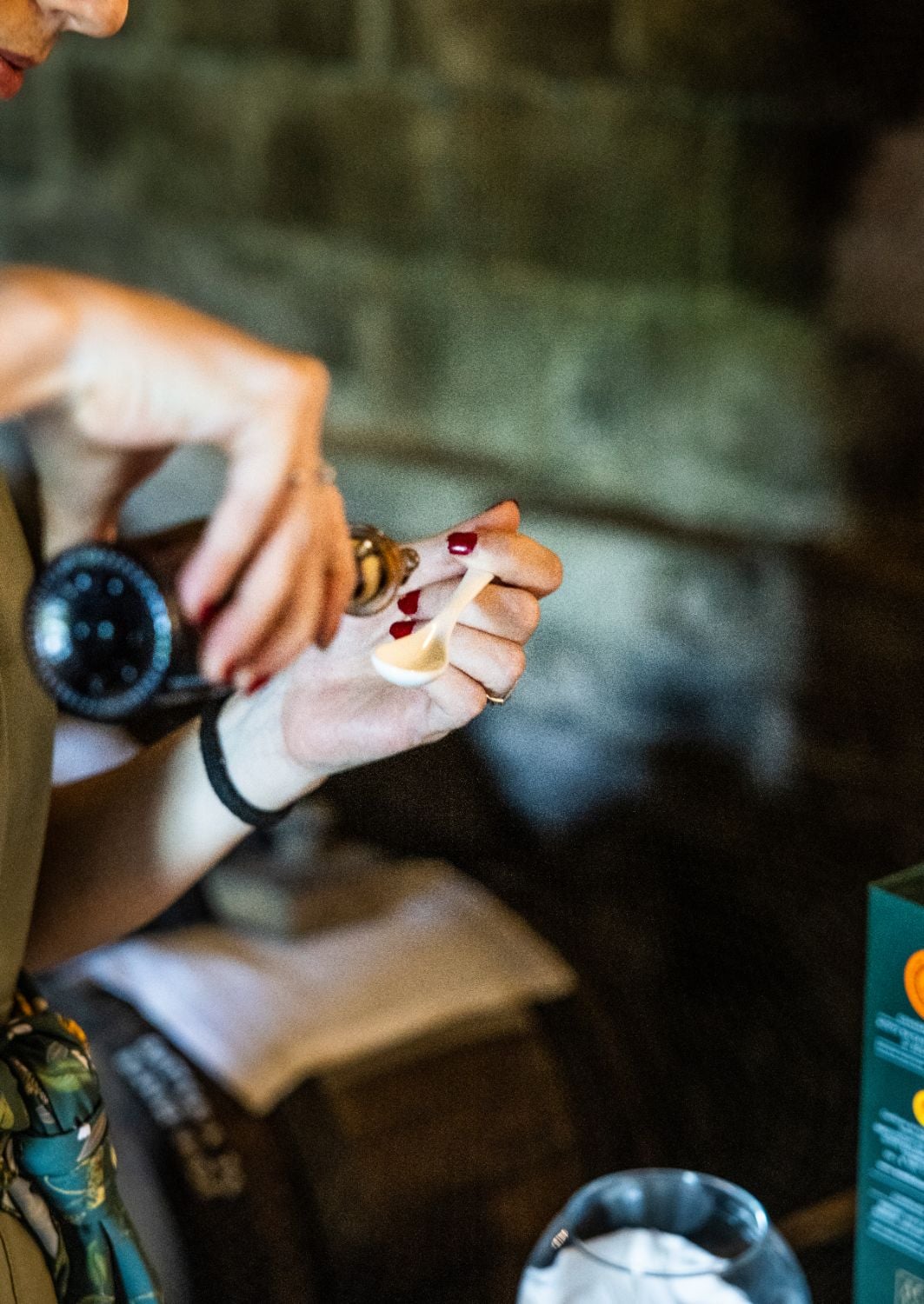Wine & Balsamico Tasting — Wine tasting experience with hands holding aged balsamic vinegar, dark red nail polish, luxury hospitality setting, European culinary tradition.