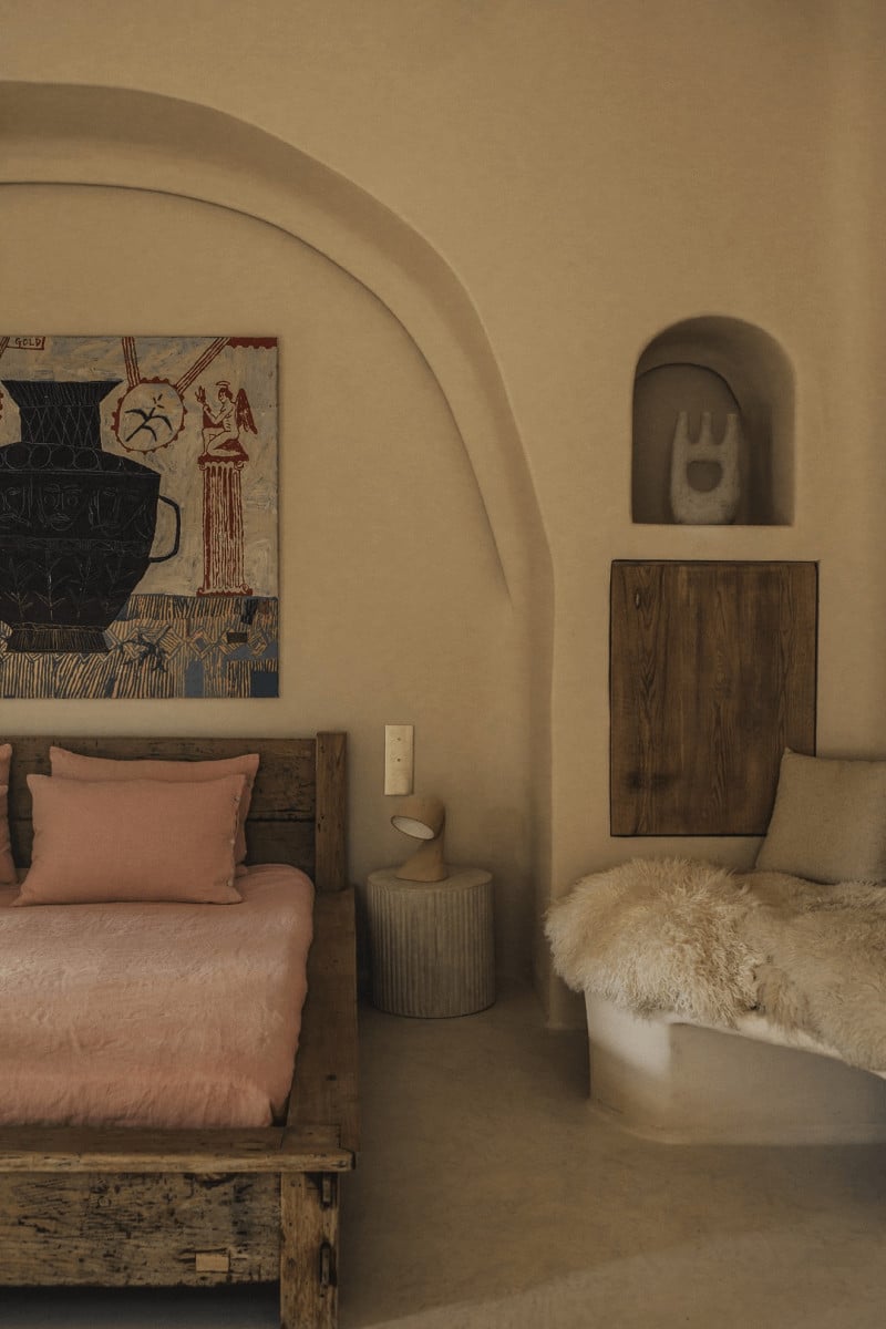 Hotel Corazón, Balearic Islands, Spain — Arched bedroom alcove with terracotta bedding, wooden furniture, curved plaster walls, and Mediterranean minimalist design.