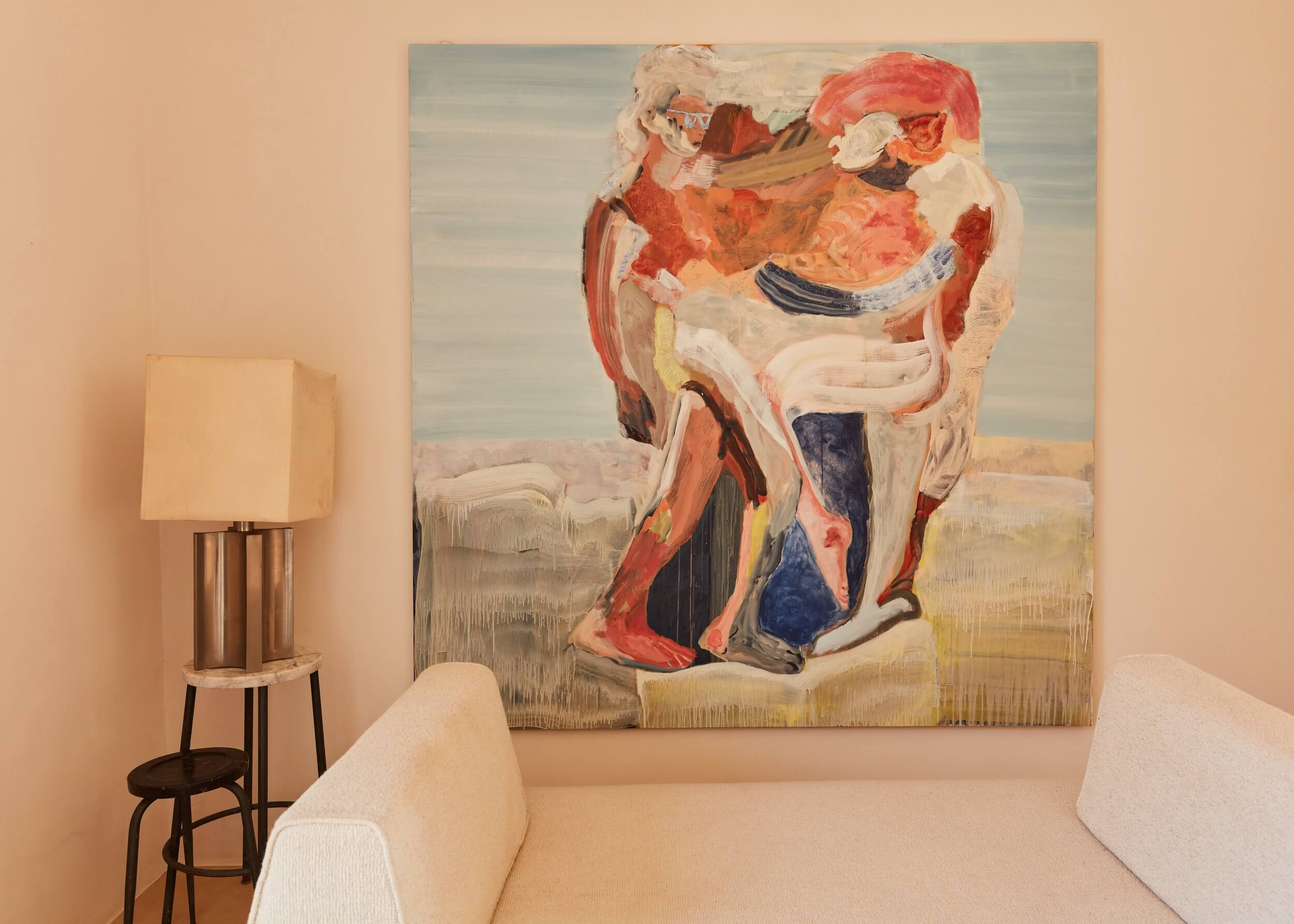 Parco Dei Sesi, Europe — Abstract anatomical painting with coral and crimson tones above cream upholstered seating and brass floor lamp in minimalist gallery space.