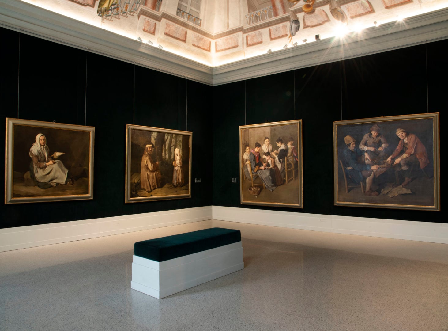 Fondazione Brescia Musei, Brescia, Italy — gallery interior with four Old Master paintings on black walls, skylit coffered ceiling, minimalist bench seating.