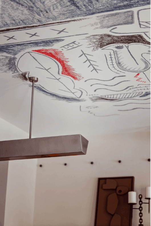 Académies et des Arts, Europe — Anatomical sketch with red watercolor accent on ceiling mural above modern bronze pendant light fixture.