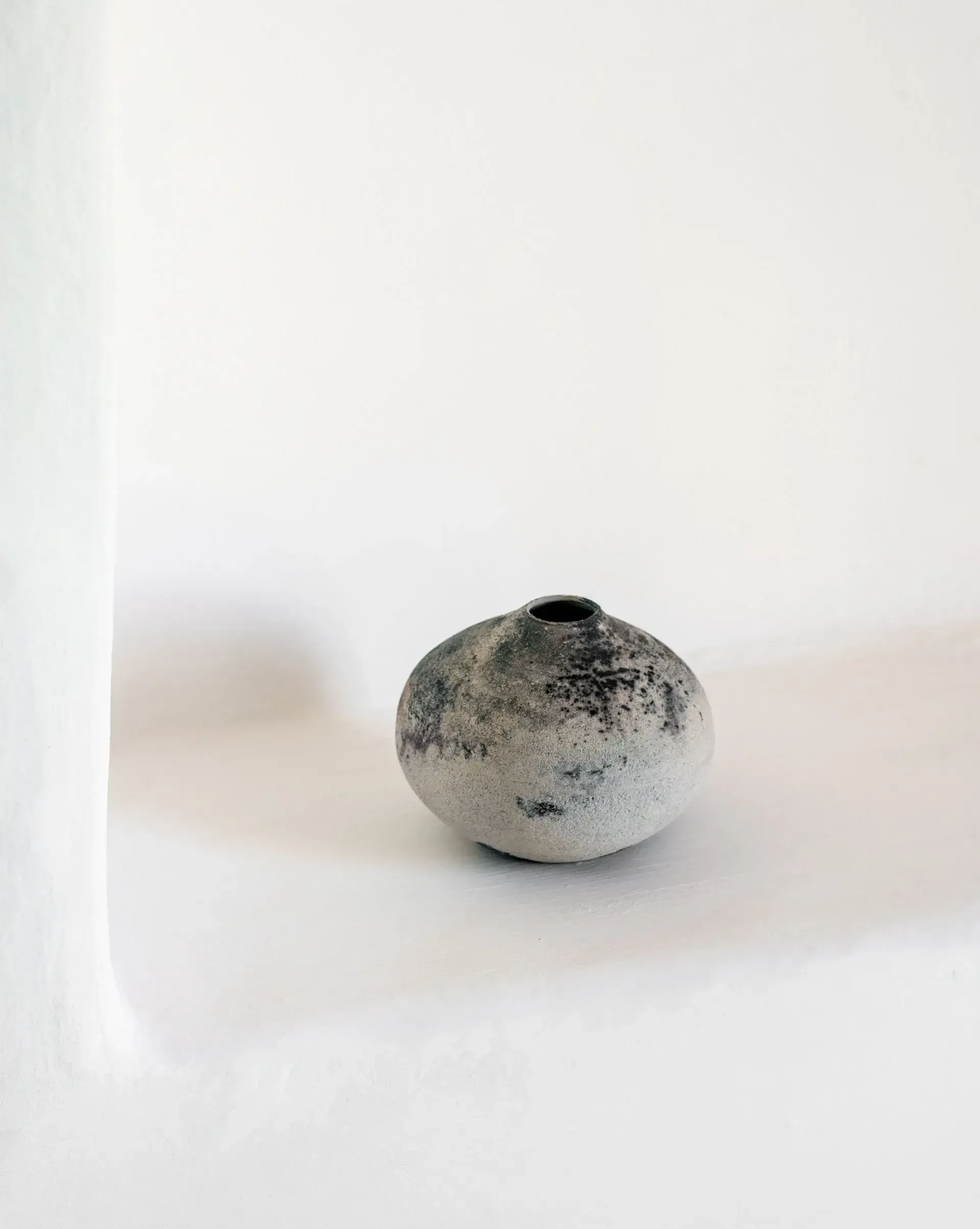 Es Racó d'Artà, Balearic Islands, Spain — Minimalist ceramic vessel with textured surface and small opening, soft natural light, refined hospitality design aesthetic