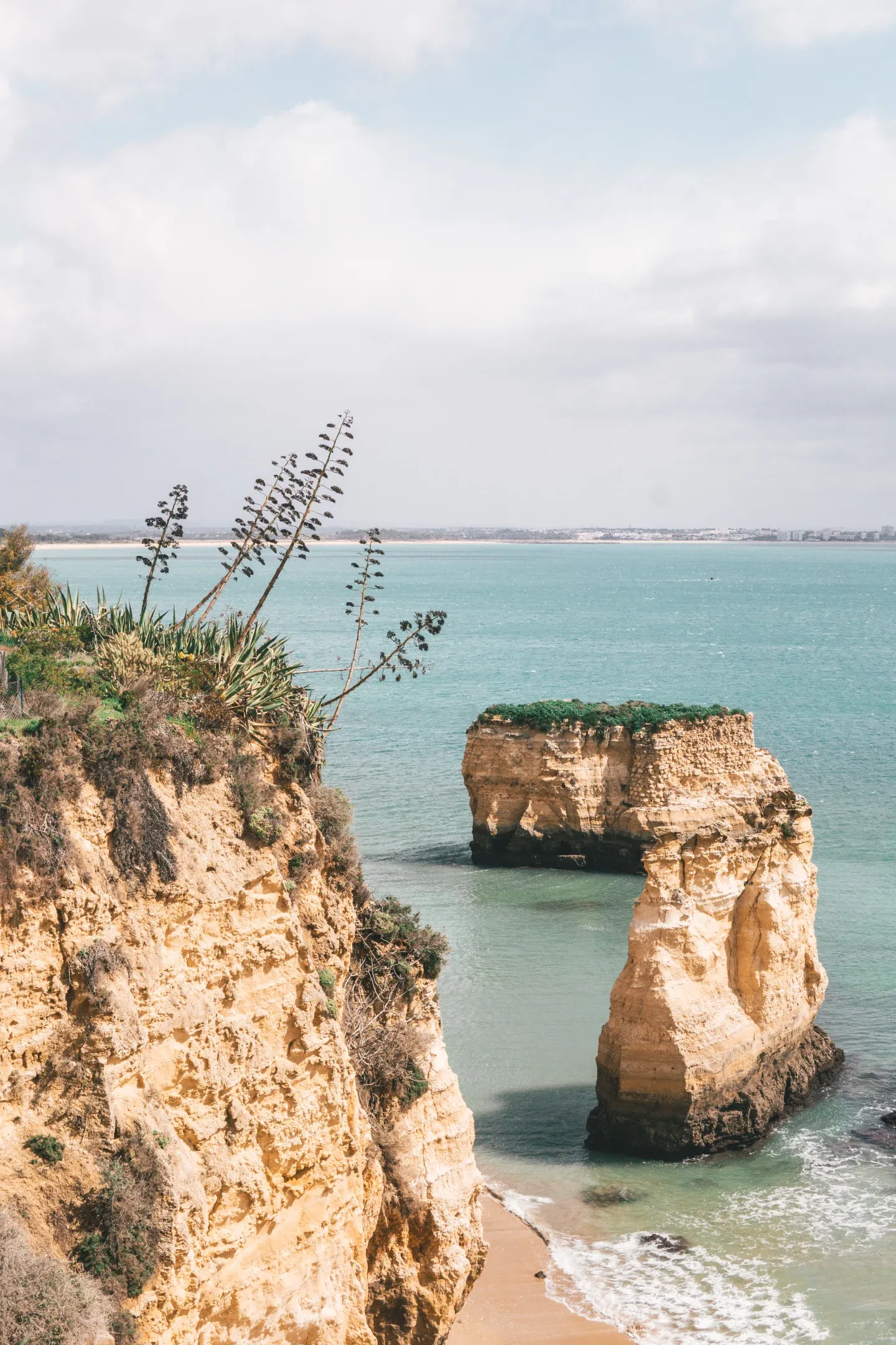 Lagos Coast, Portugal — Golden limestone cliffs and turquoise waters with sculpted rock formations, coastal Mediterranean landscape for luxury hospitality design inspiration.