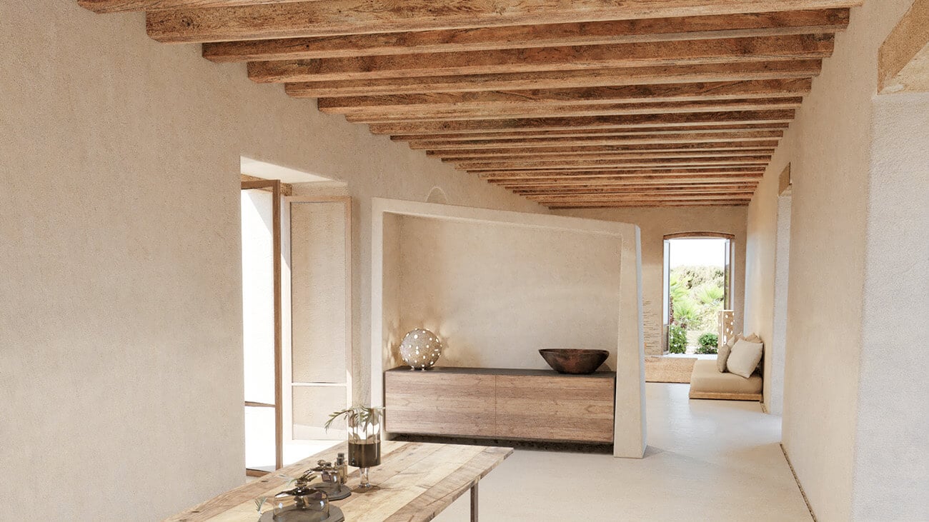 Es Racó d'Artà, Balearic Islands, Spain — Minimalist interior with exposed wooden beams, cream walls, wooden dresser, and natural light from courtyard windows.