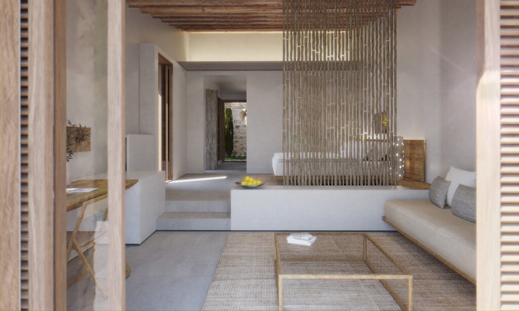 Es Racó d'Artà, Balearic Islands, Spain — Minimalist bedroom suite with natural wood accents, woven room divider, neutral linens, and Mediterranean courtyard view through glass doors.