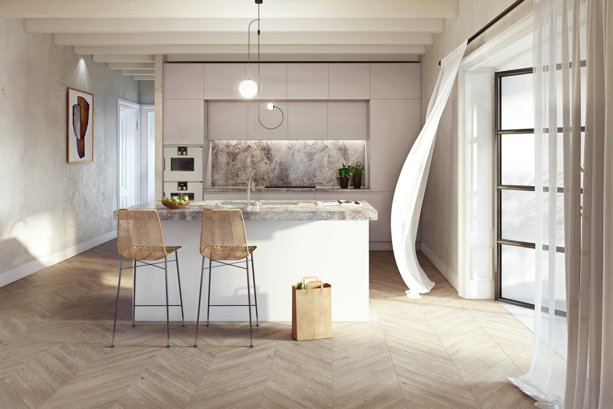Renaissance Penthouse, Balearic Islands — Modern kitchen with soft pink cabinetry, marble island, woven bar stools, herringbone wood flooring, and abundant natural light through floor-to-ceiling windows.