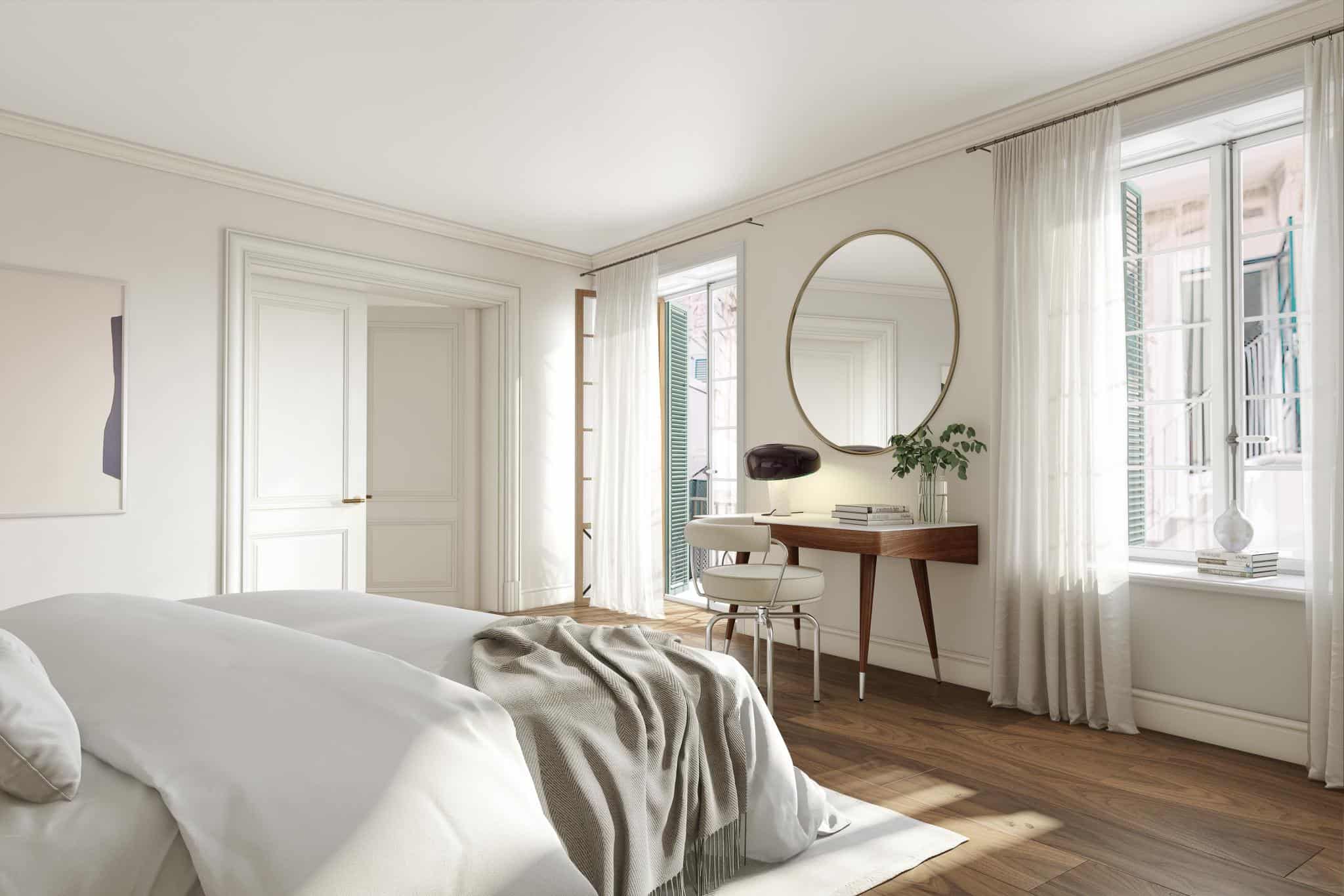Renaissance Penthouse, Balearic Islands, Spain — Minimalist bedroom with mid-century desk, oval mirror, wooden flooring, and floor-to-ceiling windows with sheer curtains overlooking city.