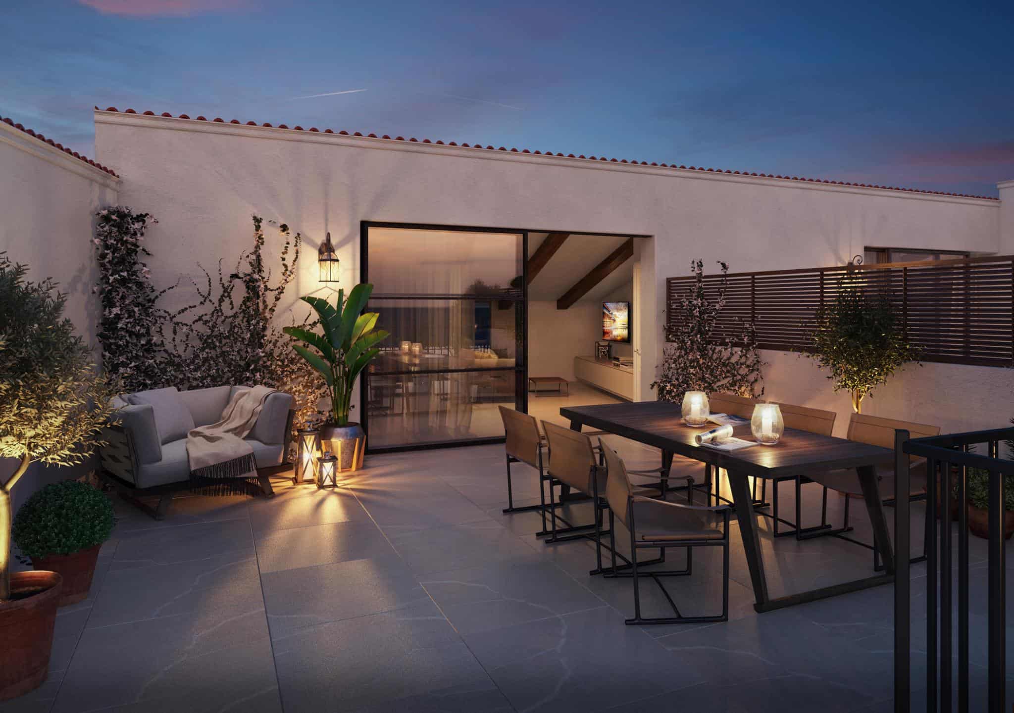Renaissance Penthouse, Balearic Islands, Spain — Modern rooftop terrace at dusk with dining table, lounge seating, potted plants, and floor-to-ceiling glass doors opening to illuminated interior.