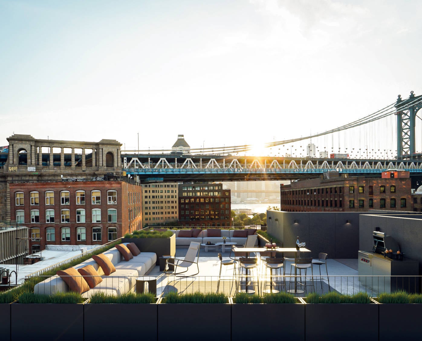 168 Plymouth, North America — Rooftop terrace with lounge seating overlooking Manhattan Bridge and East River, brick architecture, golden hour light.