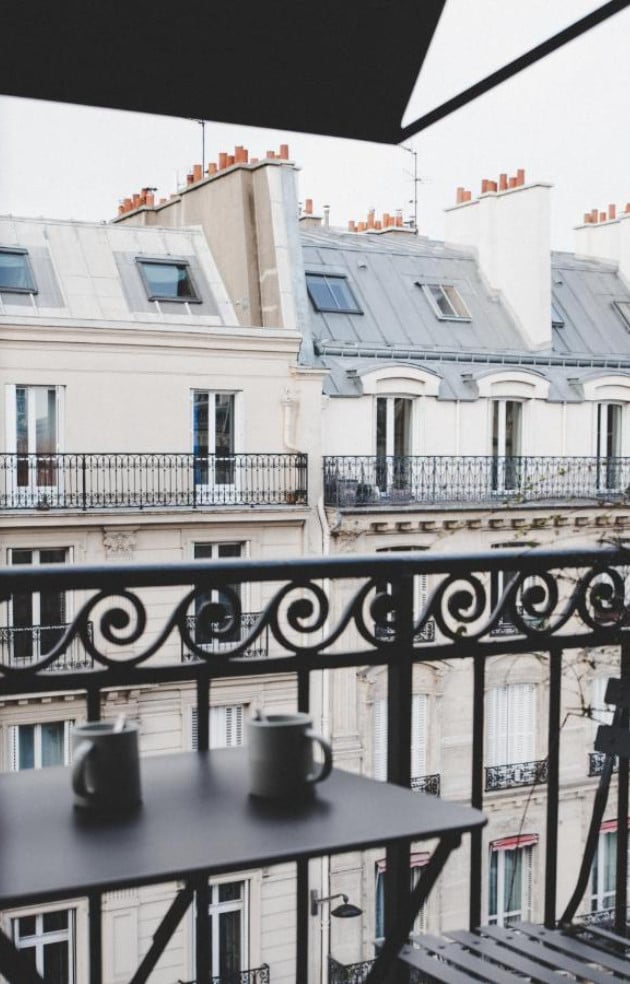 Hôtel National Des Arts, Europe — Balcony view of Haussmann architecture with mansard roofs, wrought-iron railings, and cream-colored stone facades.