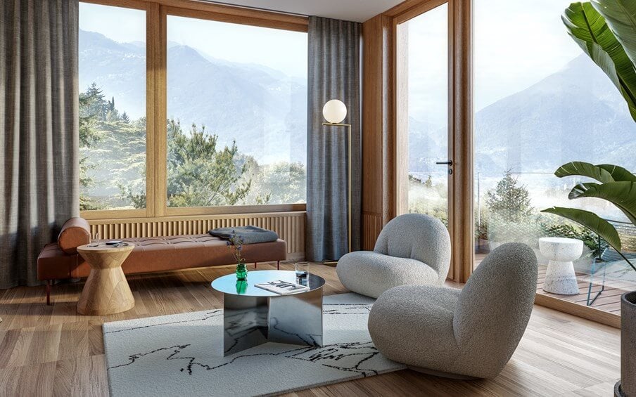 The Cōmodo — Cōmodo, Europe — Modern living room with curved gray chairs, cognac sofa, mountain views through floor-to-ceiling windows, natural wood frames, contemporary design.
