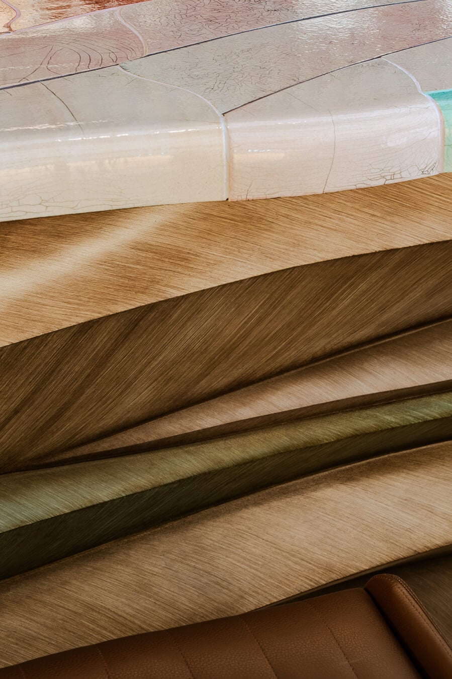 Carlton Cannes, Cannes, France — Layered wood flooring samples in warm tones with textile swatches and protective wrapping, showcasing luxury interior finishes.